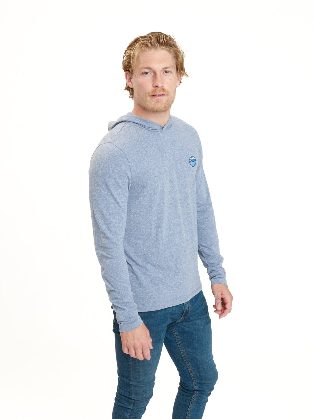 Men wearing a blue long sleeve triblend t-shirt hoodie in a casual outdoor setting