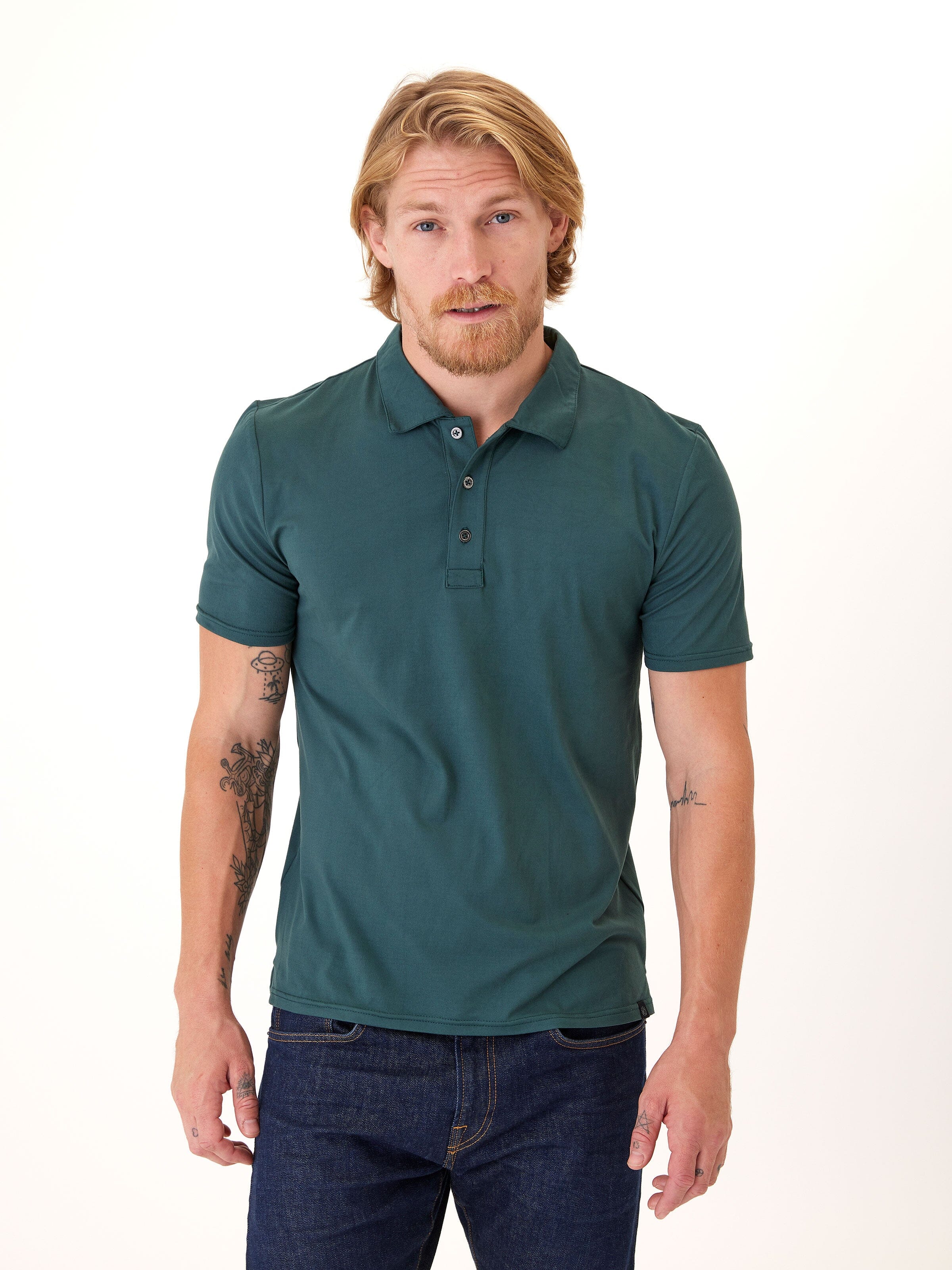 Man wearing a solid dark-teal Luxe Jersey polo shirt in a minimalist style