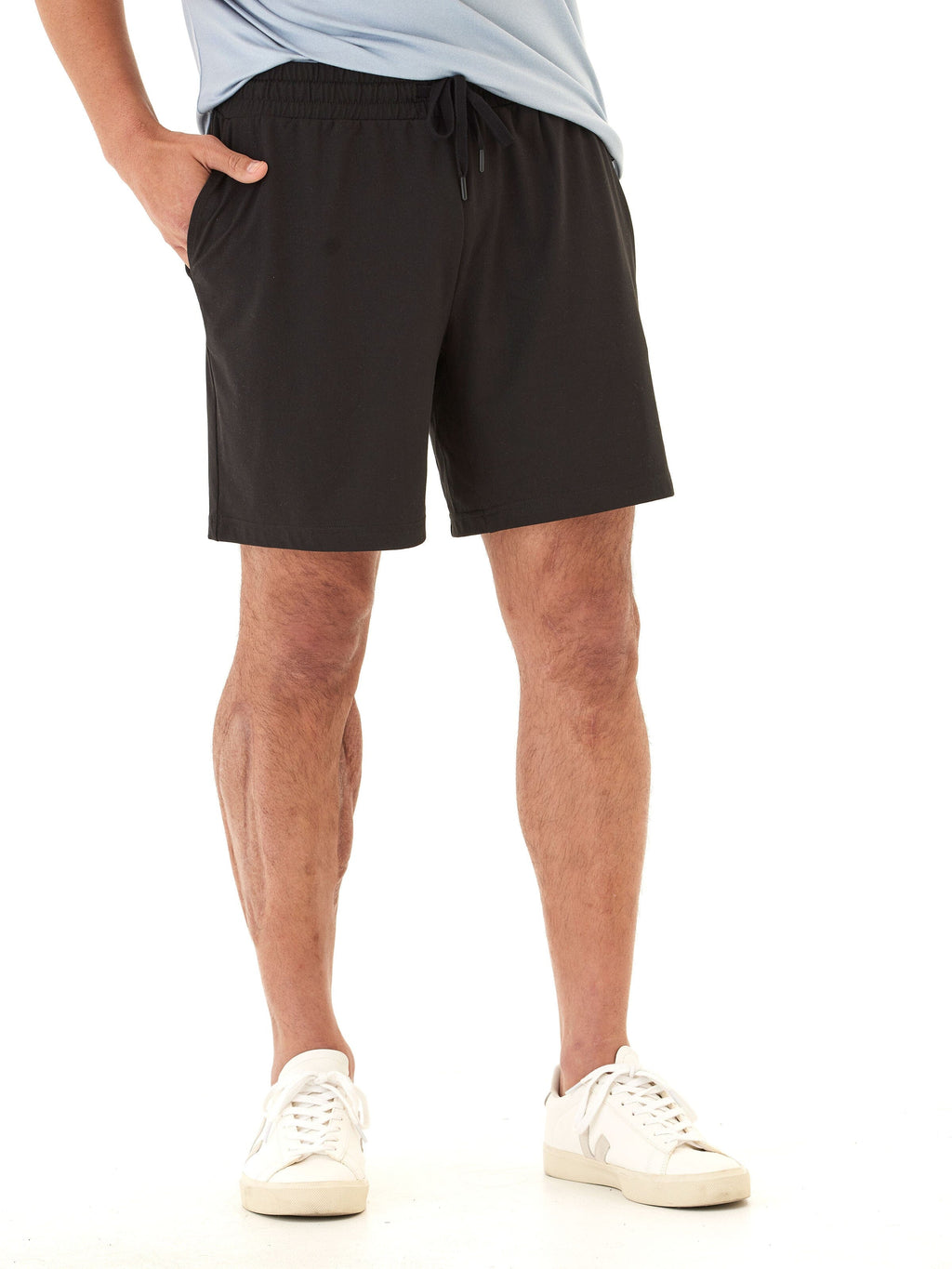 Men wearing black minimalist Luxe Jersey mid-length shorts with an elastic drawstring waist.