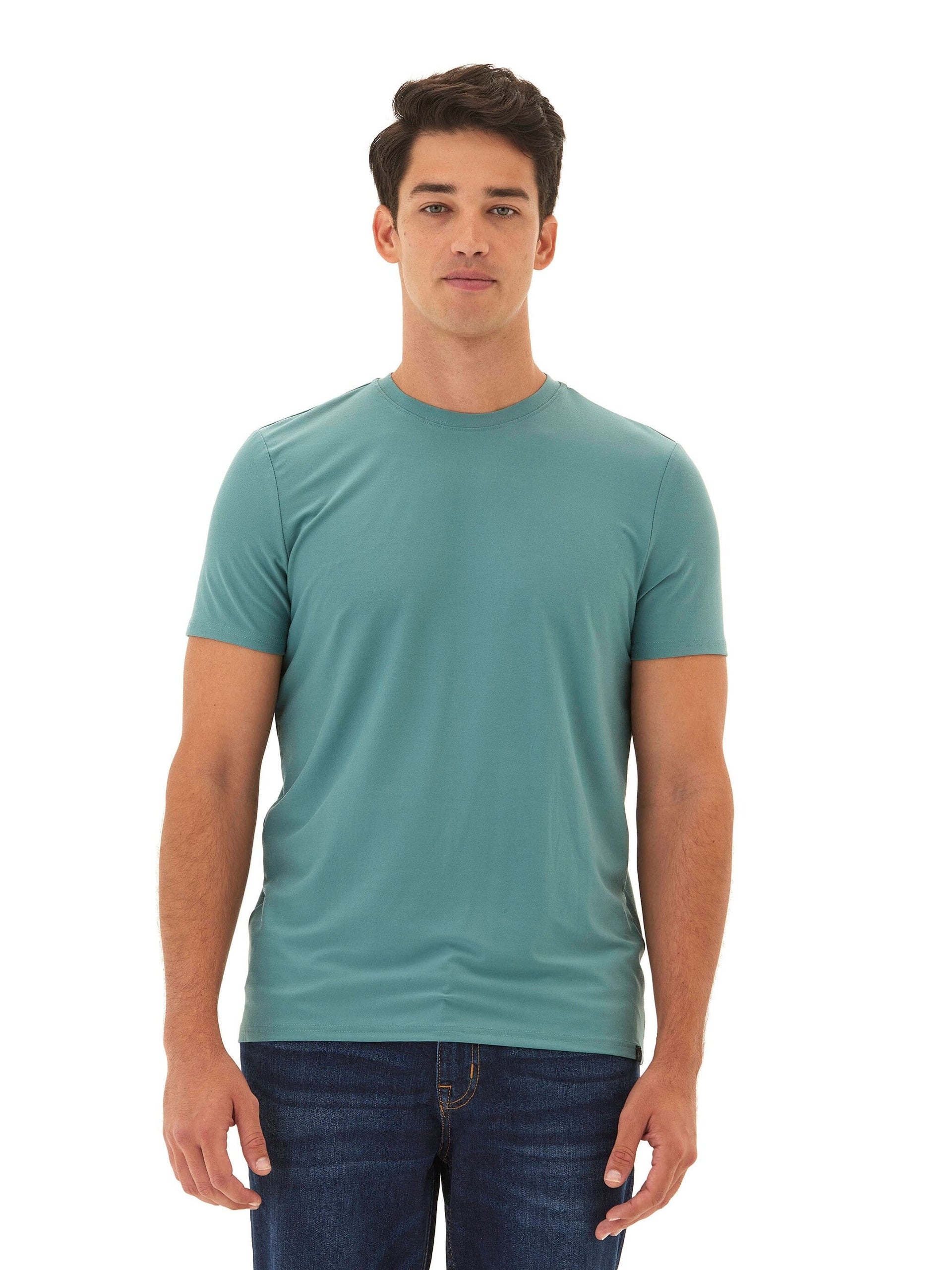A man wearing a solid muted teal Men's Core Luxe Jersey Crew Neck Tee with a classic fit.
