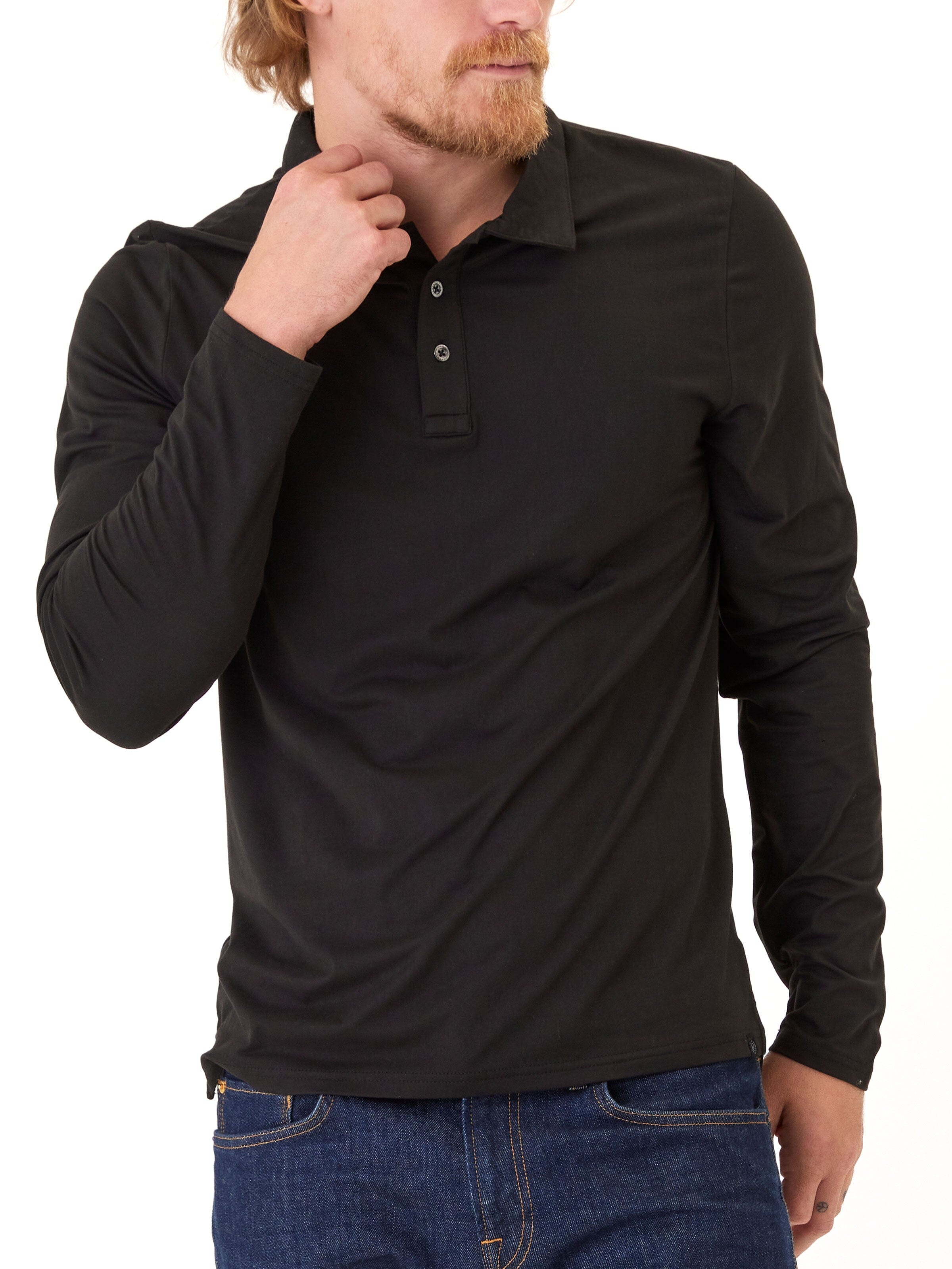 Man wearing a solid black luxe jersey long sleeve polo shirt.