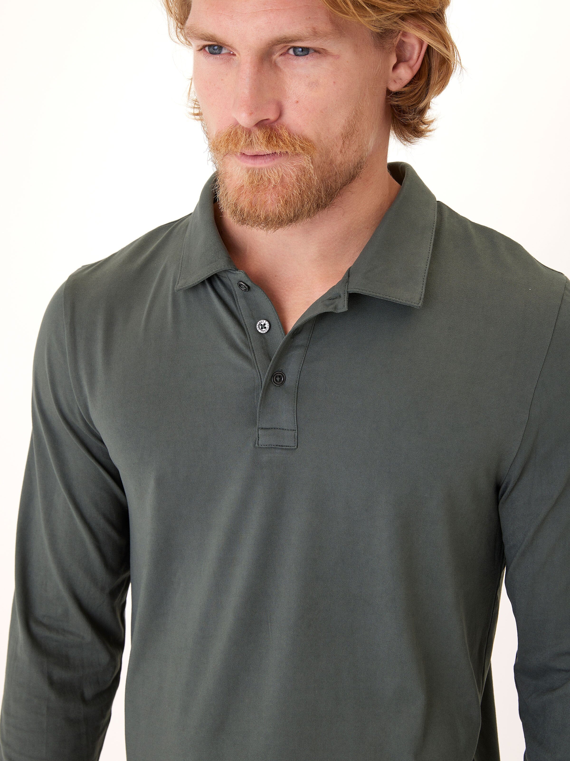Close-up of Luxe Jersey Long Sleeve Polo featuring soft stretch fabric and classic collar design.