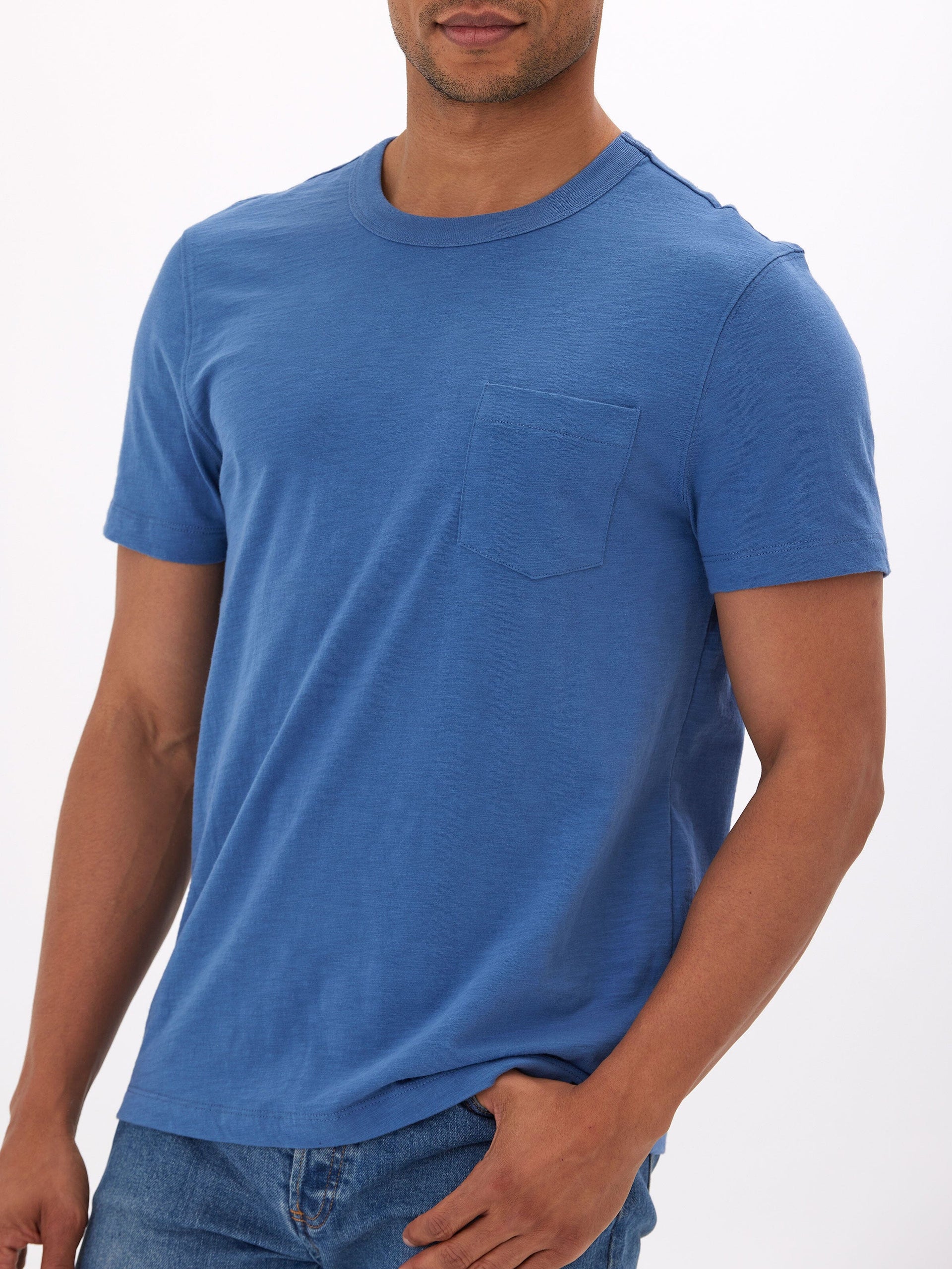 Men wearing a blue organic cotton slub jersey pocket tee with a minimalist design.