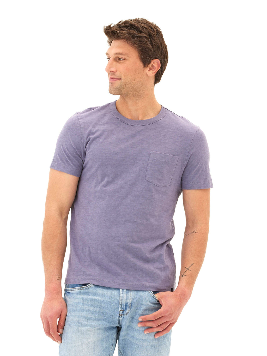 Men wearing a purple minimalist slub jersey pocket tee made of organic cotton.