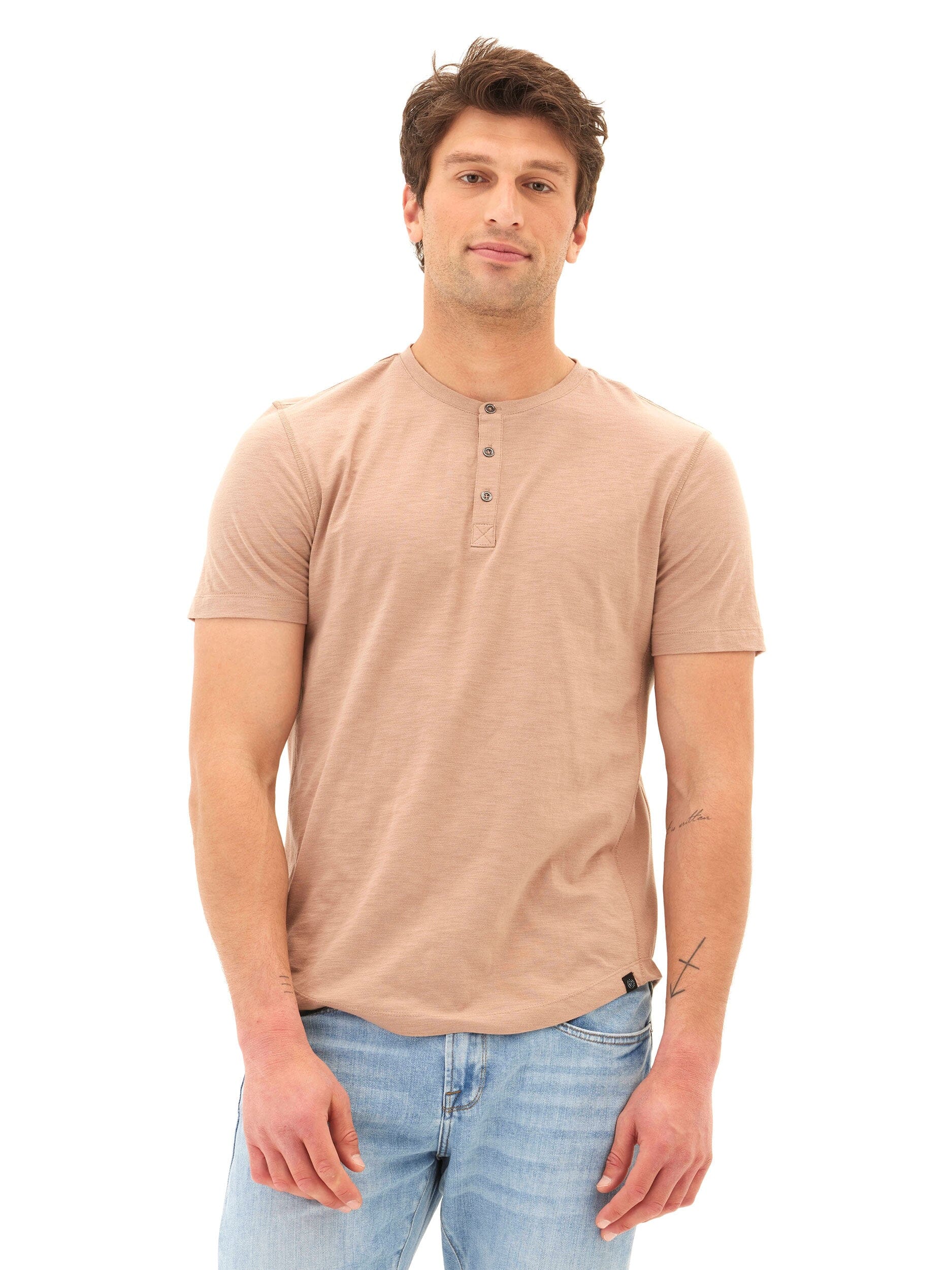Men wearing a tan Heath Slub Jersey Short Sleeve Henley with three-button detail.
