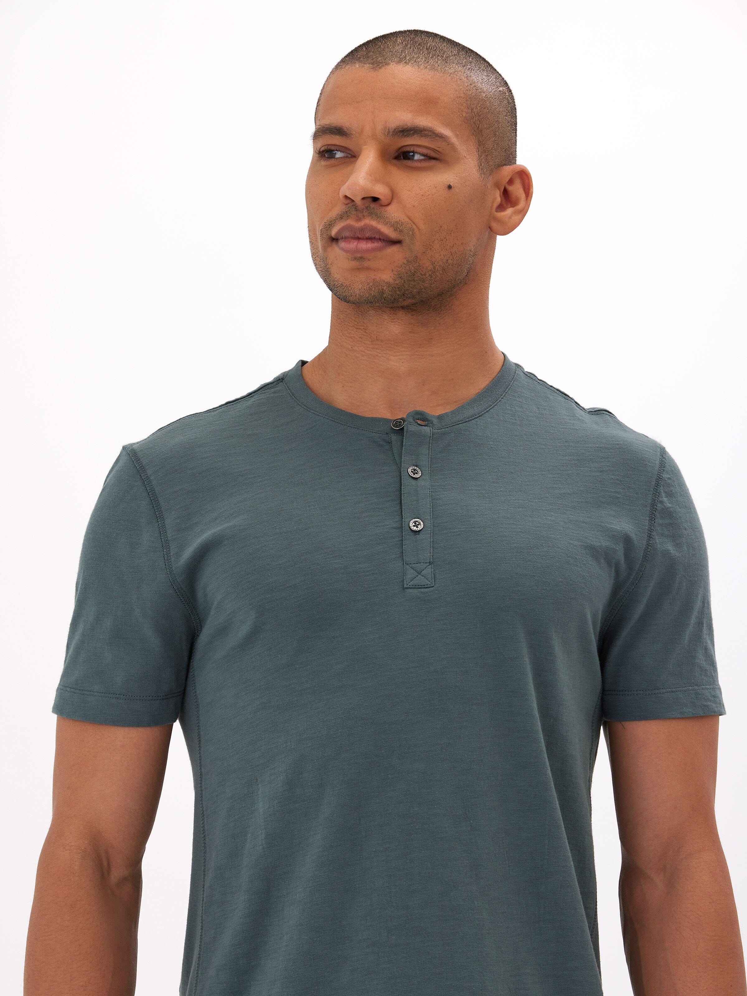 Men's dark teal short sleeve henley made from organic cotton slub jersey.