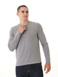 Men wearing a solid grey long sleeve knit henley shirt with a minimalist design.