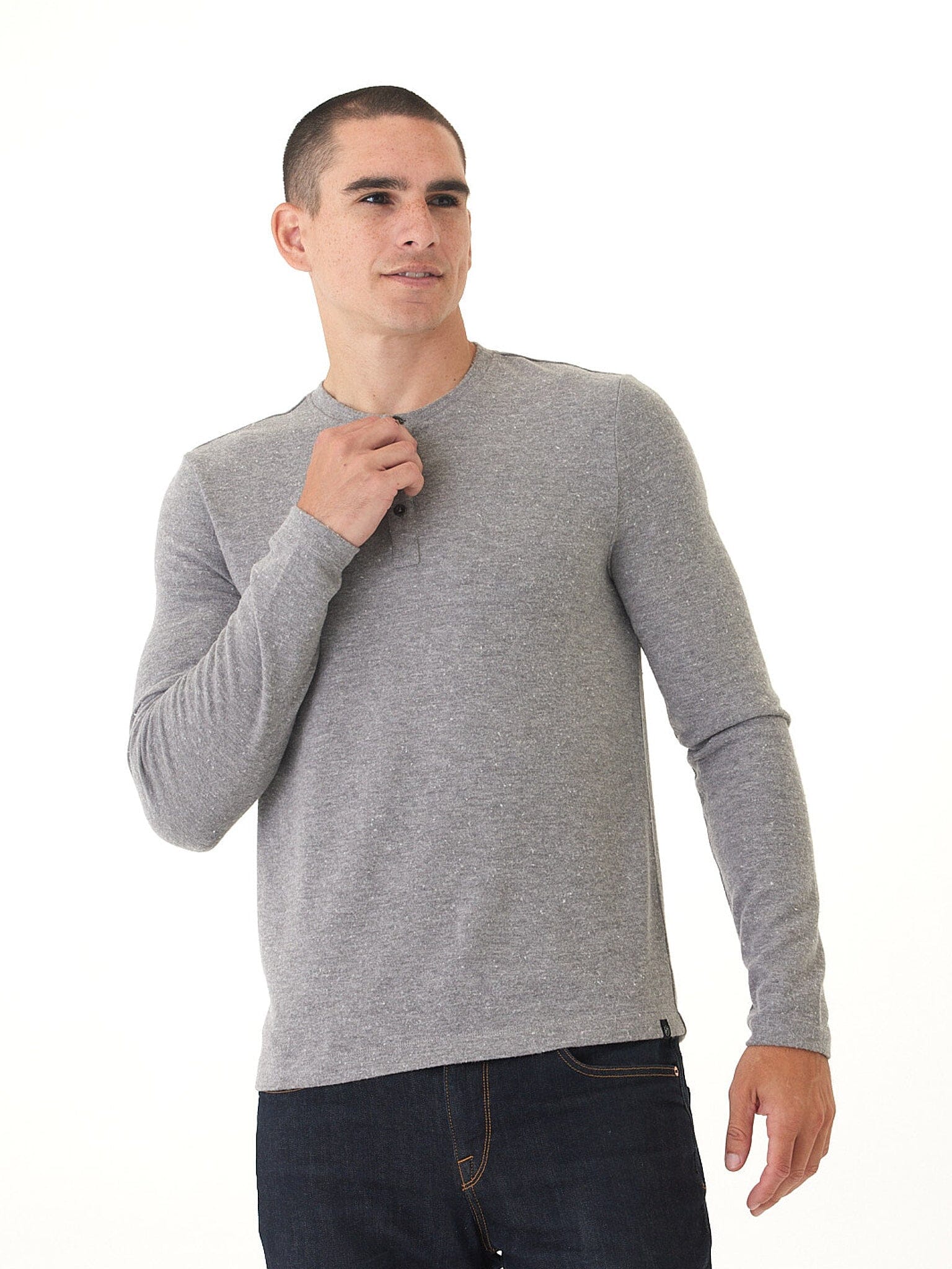 Men wearing a solid grey long sleeve knit henley shirt with a minimalist design.