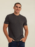 Man wearing a charcoal grey Gil sweater knit short sleeve tee with a clean tailored fit.