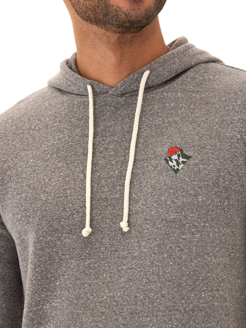 Men wearing a grey triblend fleece knit hoodie in a sporty casual style.