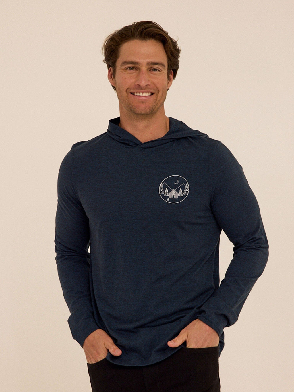 Close up of the Triblend Embroidery Hoodie Tee featuring a small chest embroidery detail.