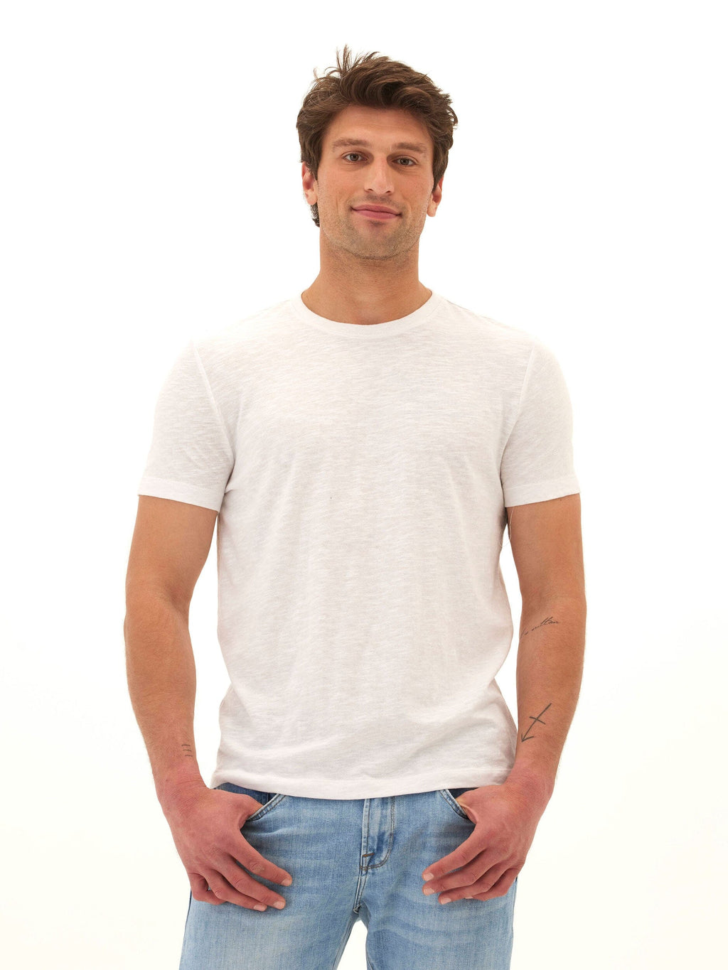 Men wearing a white slub linen short sleeve crew neck tee with a textured finish