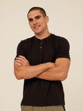 Model wearing a Shayne Luxe Jersey Henley short sleeve shirt with a three-button placket.