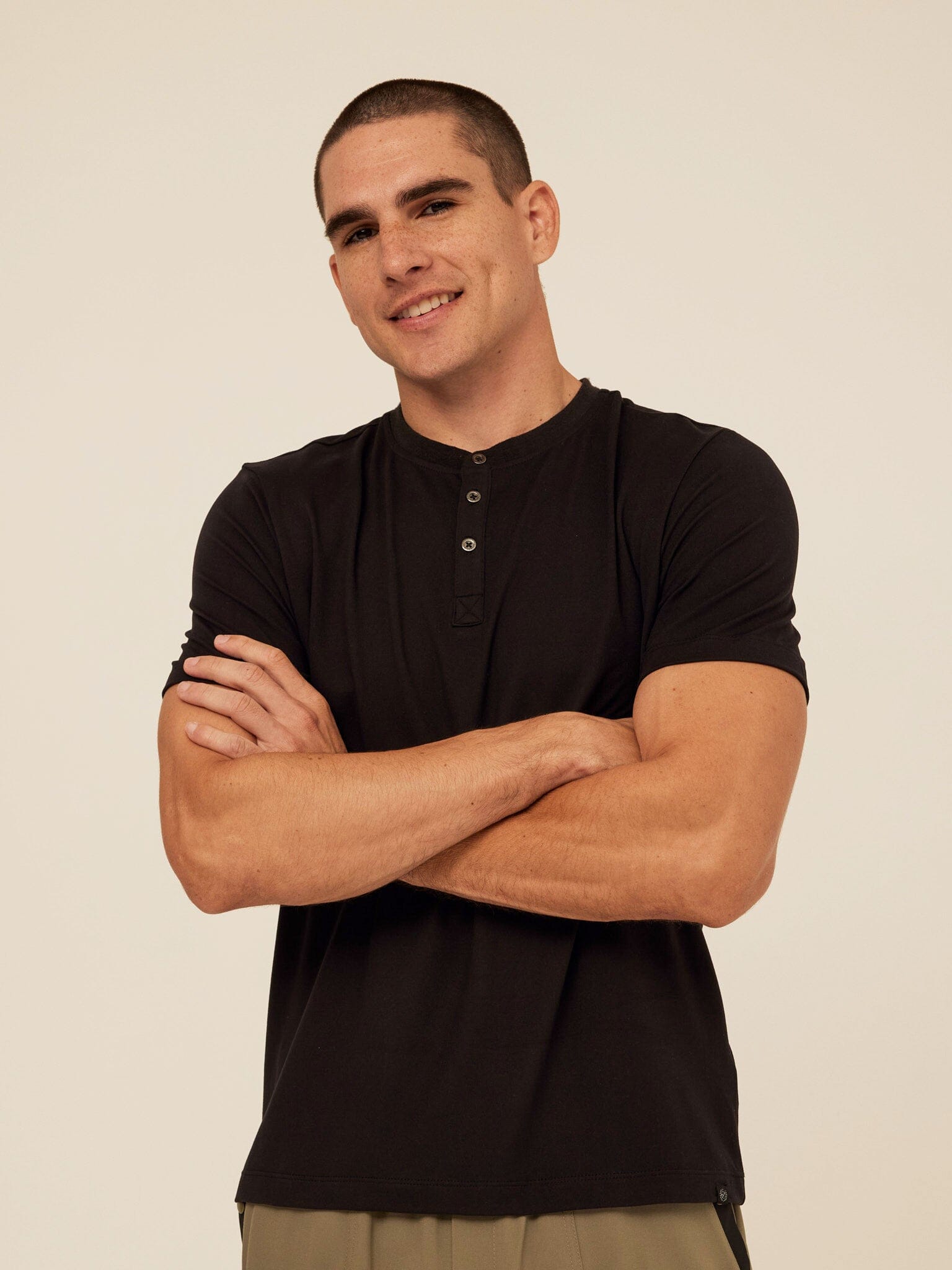 Model wearing a Shayne Luxe Jersey Henley short sleeve shirt with a three-button placket.