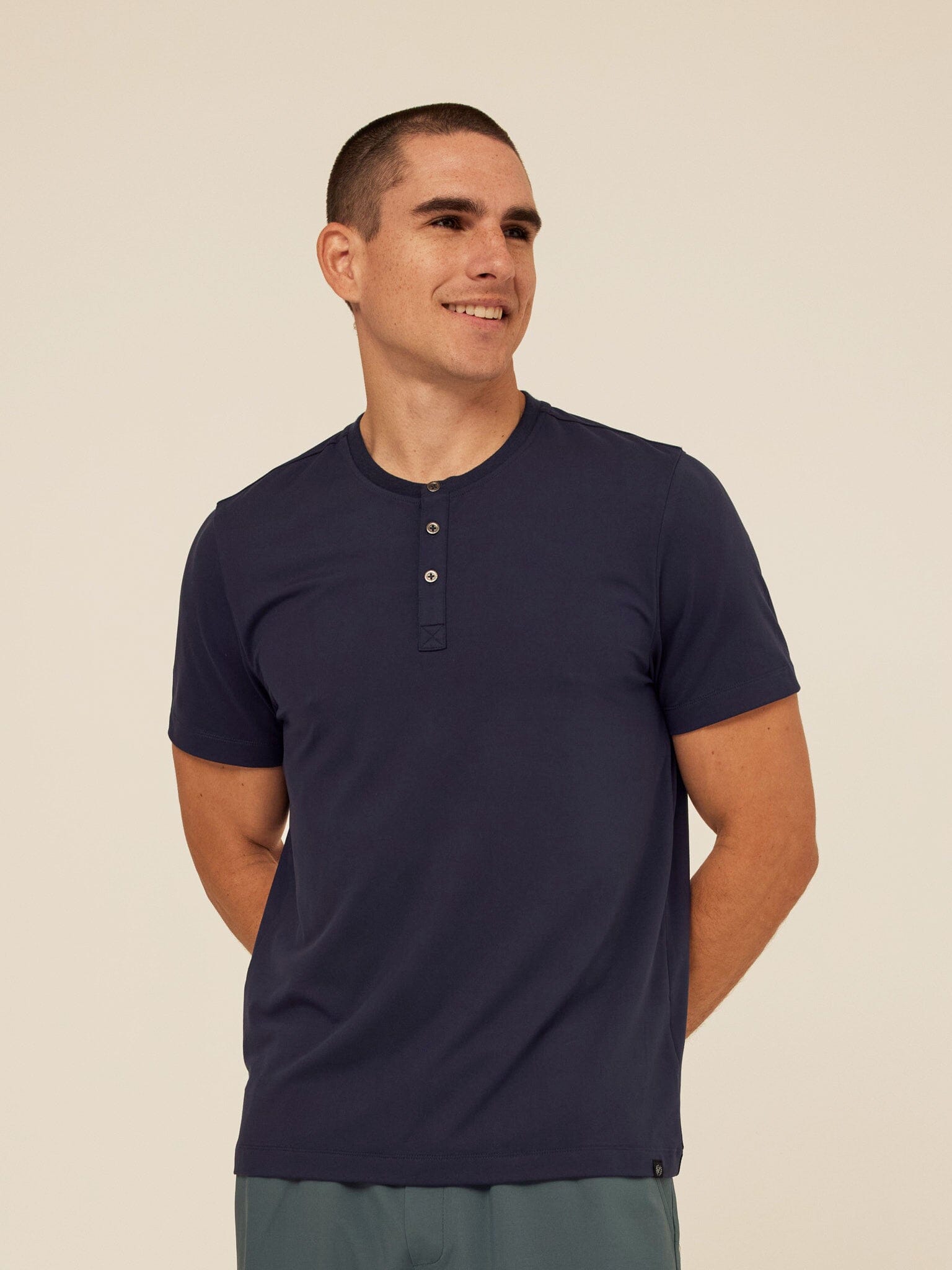 Close up of men's navy blue short sleeve Luxe Jersey Henley featuring a three-button placket.