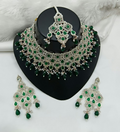 Exquisite green stone necklace set with matching earrings and maang tikka for festive wear