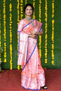 Baby pink soft handloom silk saree with intricate gold zari woven details and matching blouse