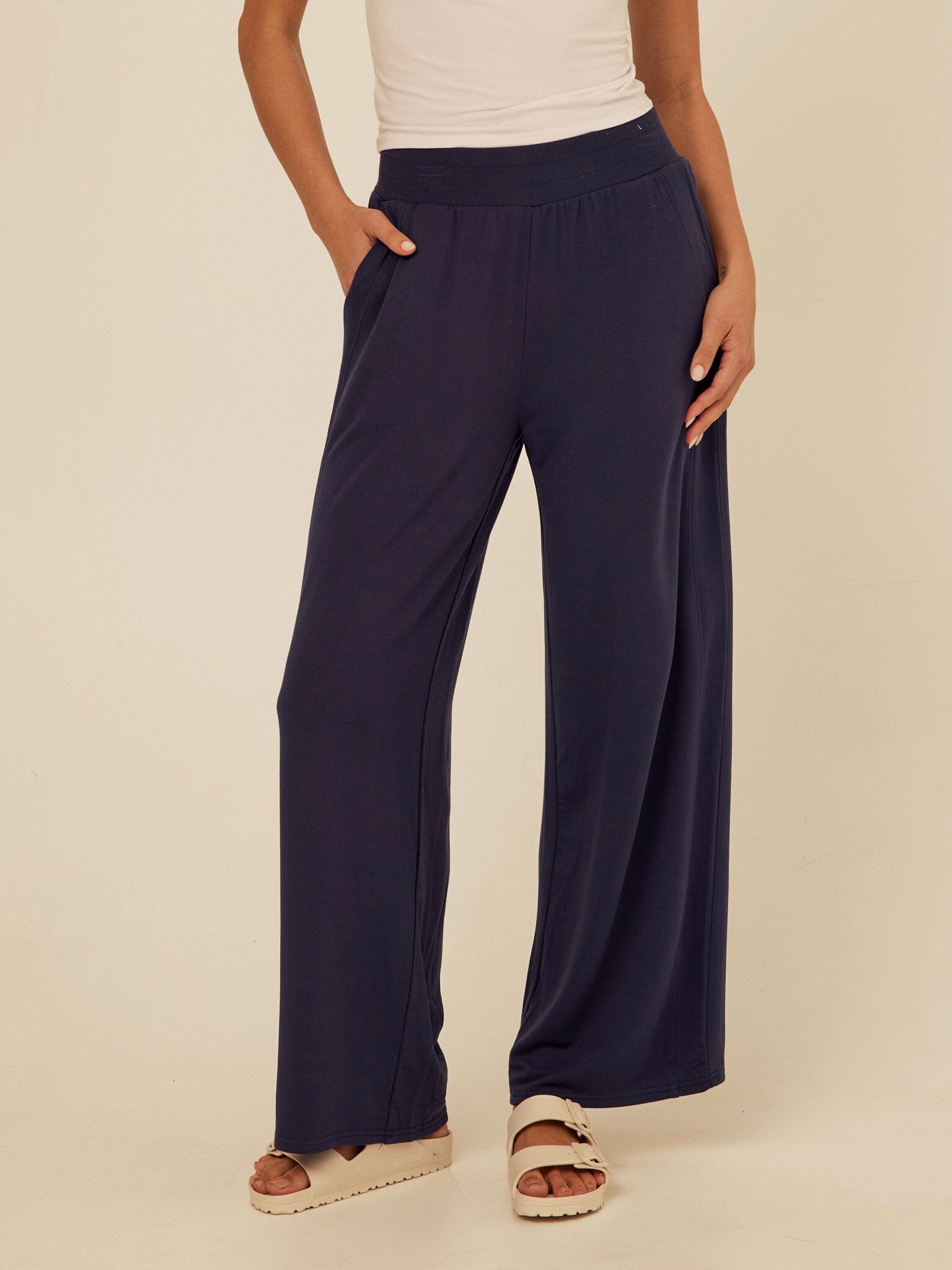 Core Feather Fleece wide-leg sweatpants in a soft, fluid fabric with an elastic waistband and side pockets.