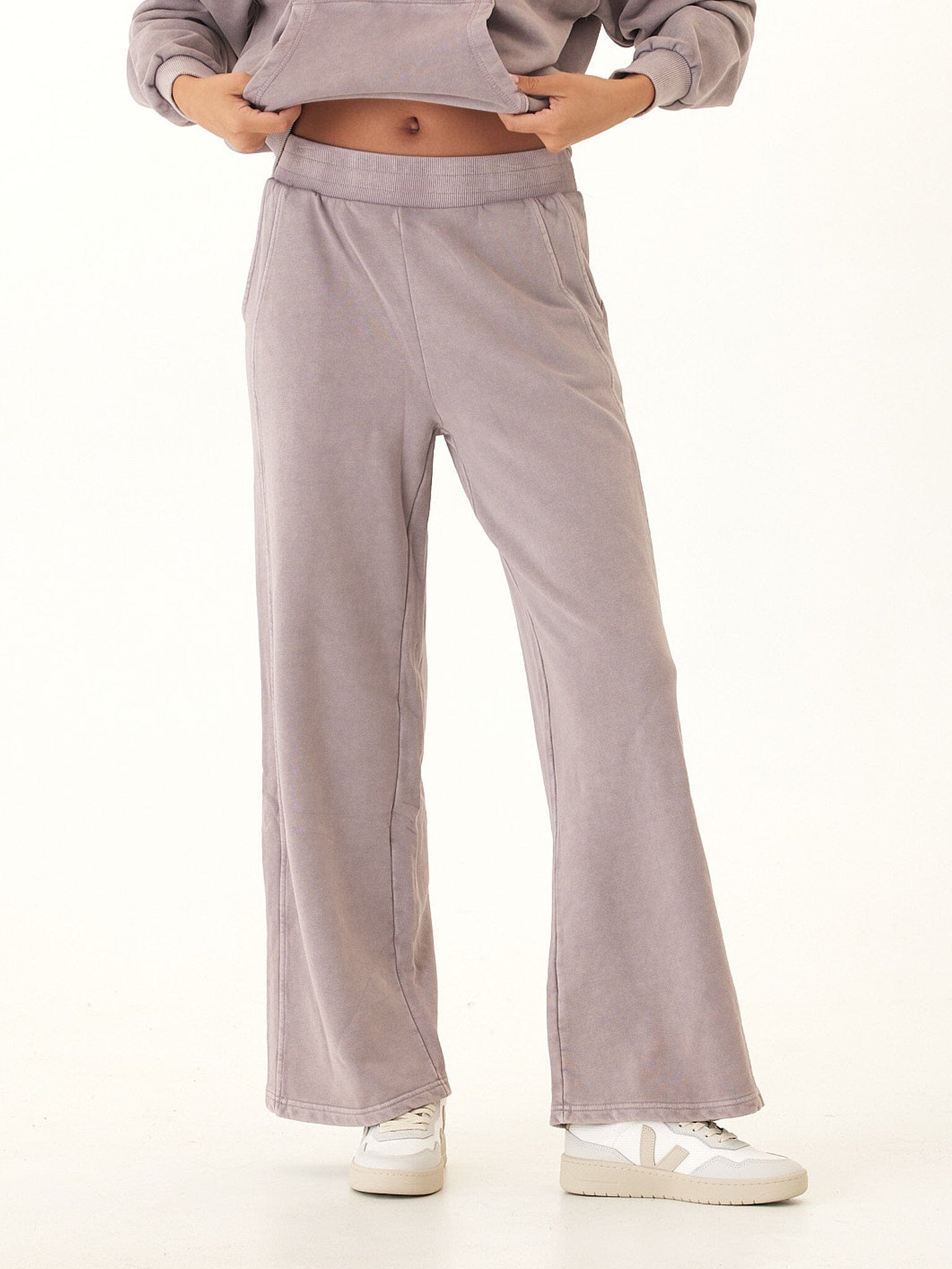Core Feather Fleece sweatpants in mauve and dusty-purple with a relaxed knit finish.