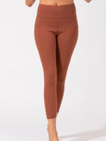 Rust colored high-rise ankle length leggings with side pockets.