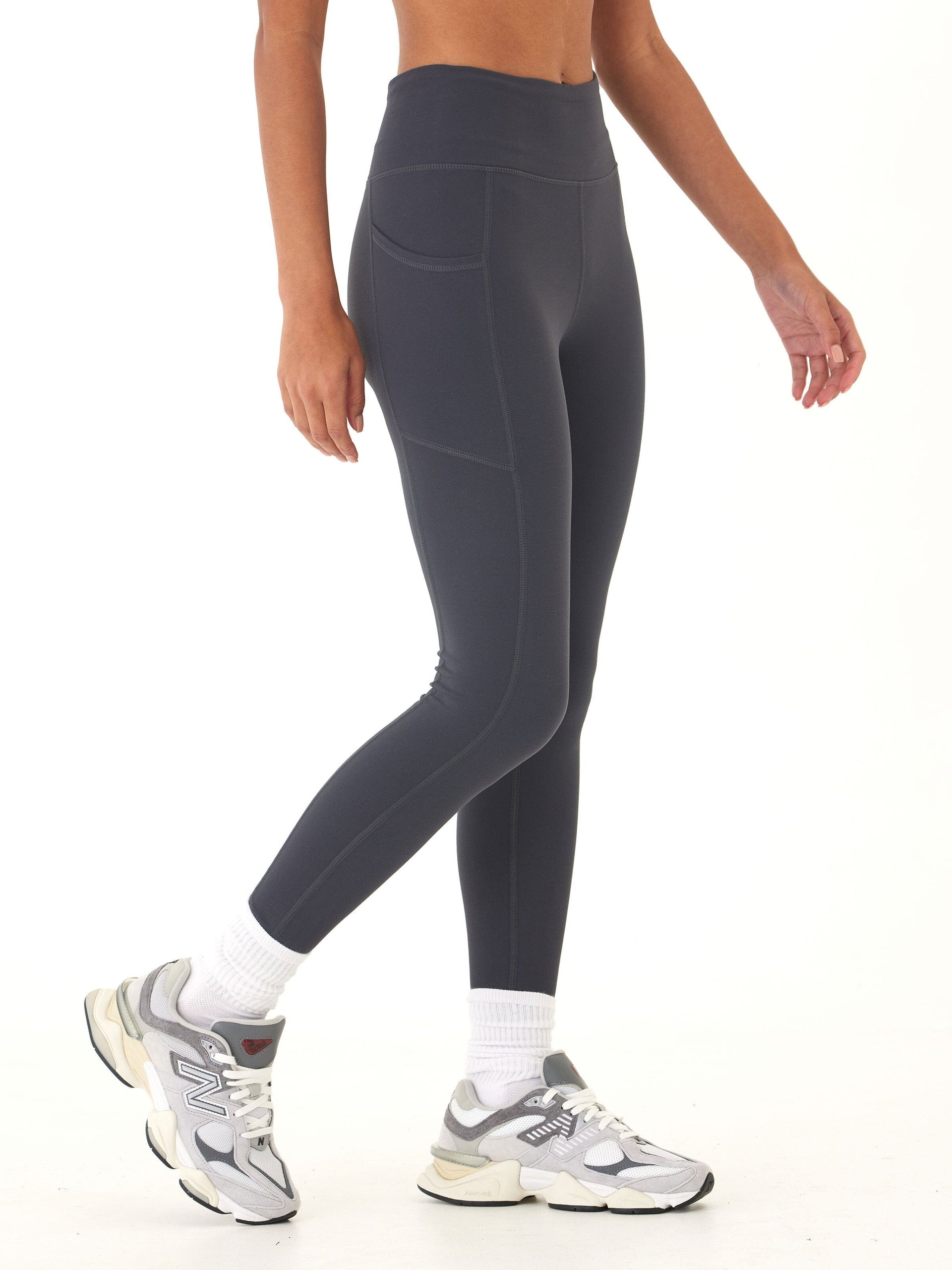 Charcoal grey ankle-length women's leggings with high-rise waistband and side pockets.
