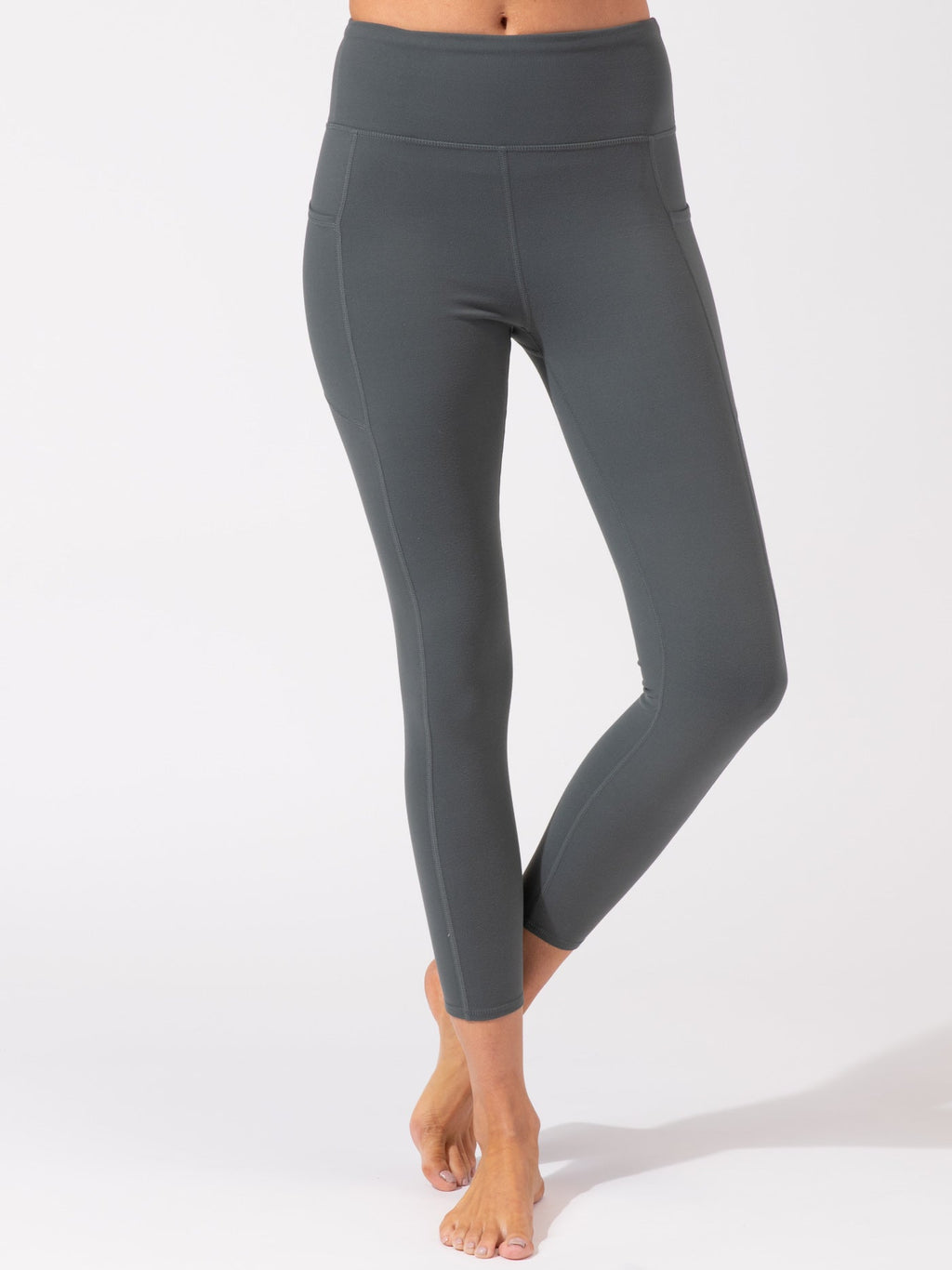 Charcoal grey ankle length leggings with high-rise waistband and side pockets.