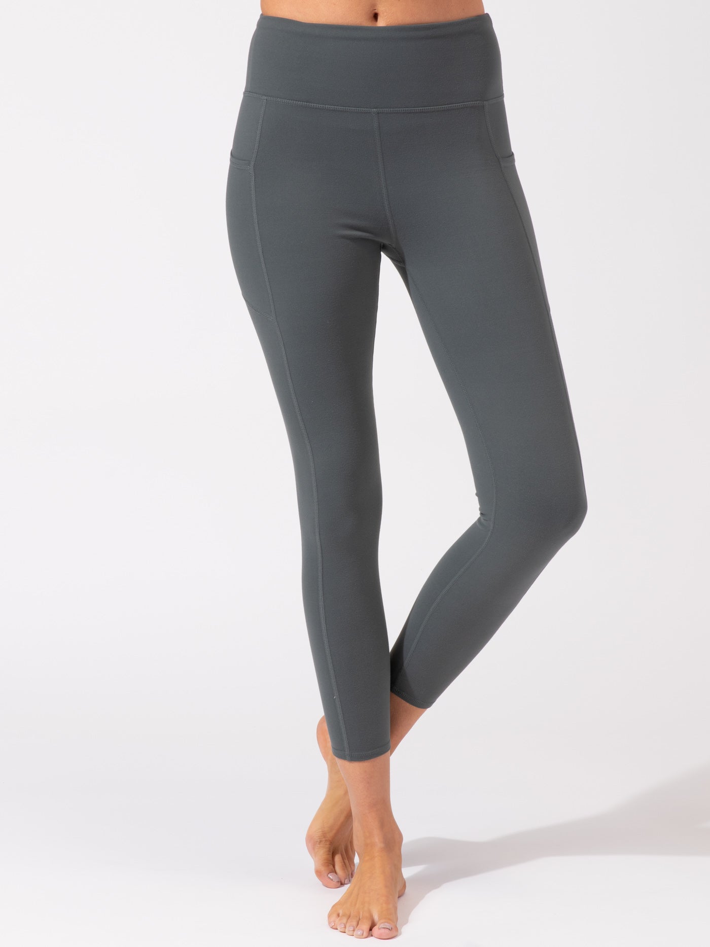Charcoal grey ankle length leggings with high-rise waistband and side pockets.