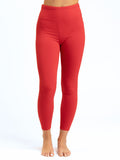 Women's minimalist vibrant red high-rise ankle length leggings with a tapered fitted silhouette.