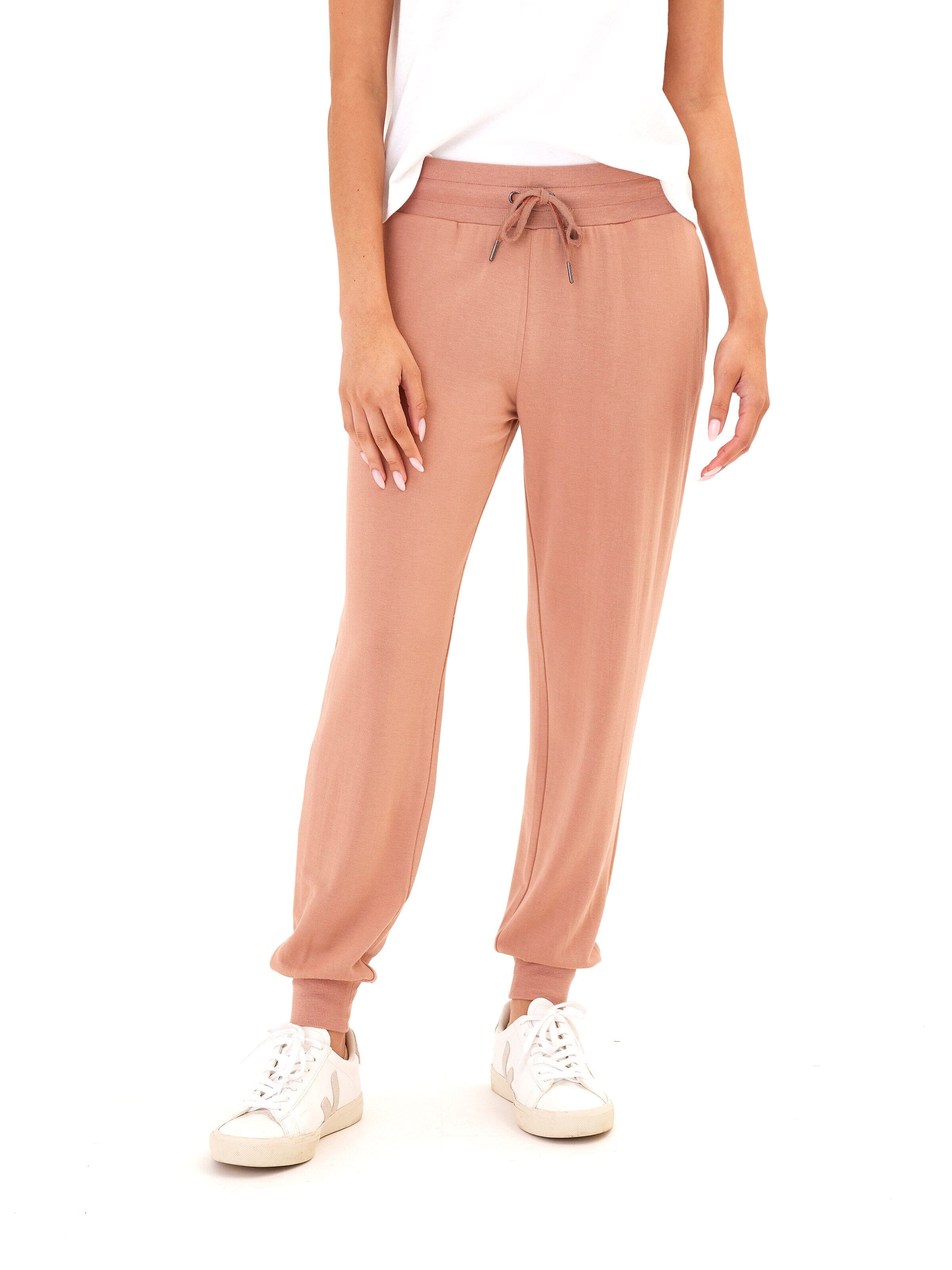 Women wearing comfortable dusty rose Feather Fleece joggers with a tapered ankle and ribbed cuffs