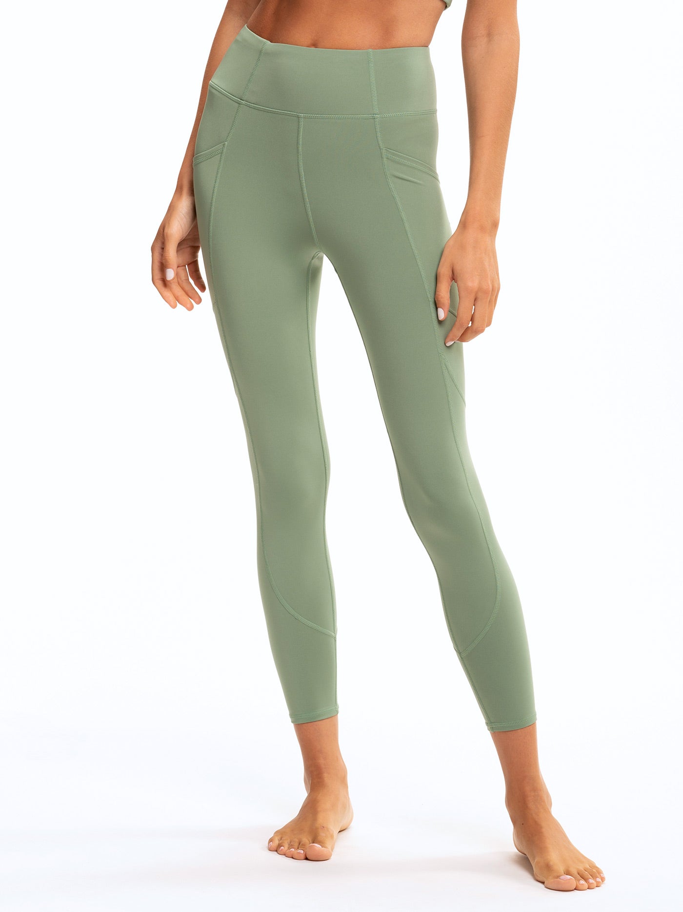 Rita High Rise 7/8 Sport Legging in sage green with side pockets and flat-lock seams.