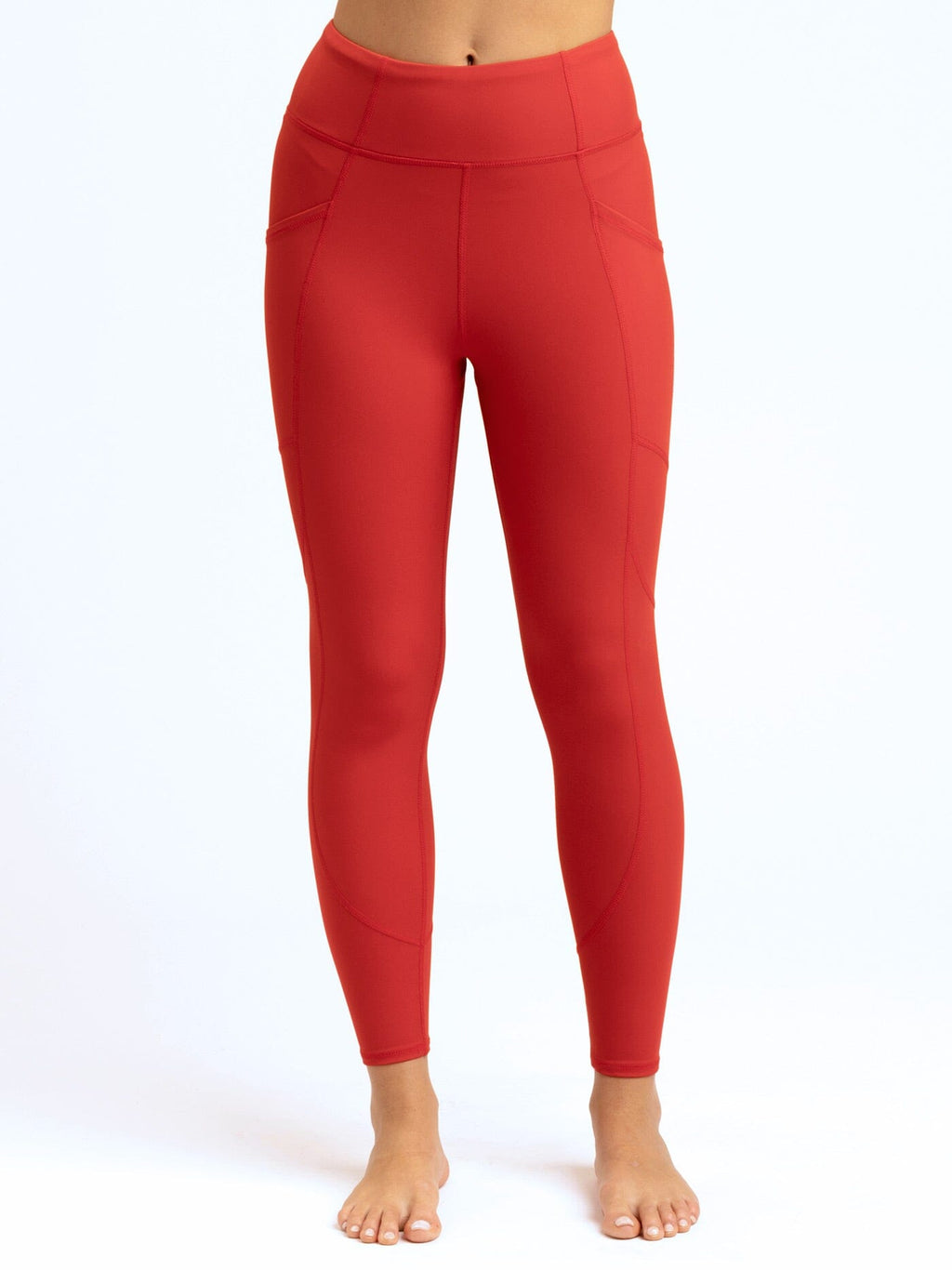 Rita 7/8 high rise sport legging with side pockets and flat-lock seams in recycled performance fabric.