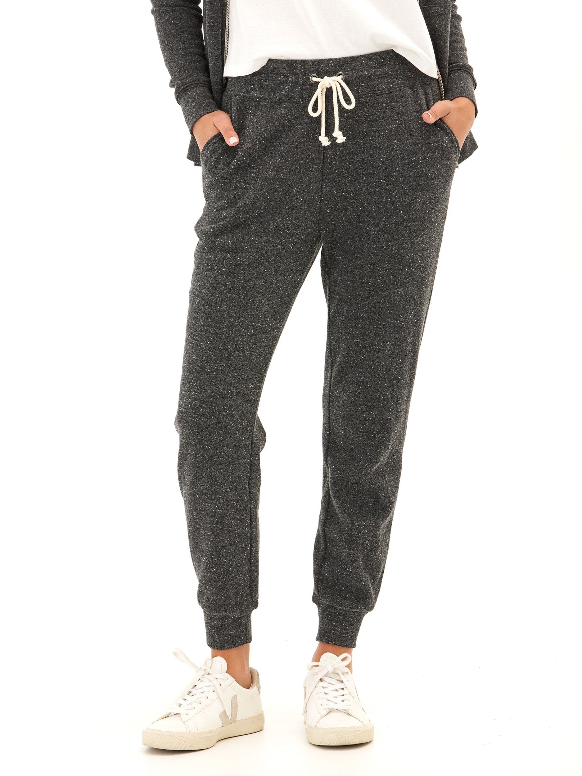 Slim fit triblend jogger in charcoal with side pockets and a drawstring waist, styled for an athleisure look.