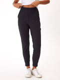 Woman wearing minimalist black Peached Performance Jersey Lydia joggers with pockets