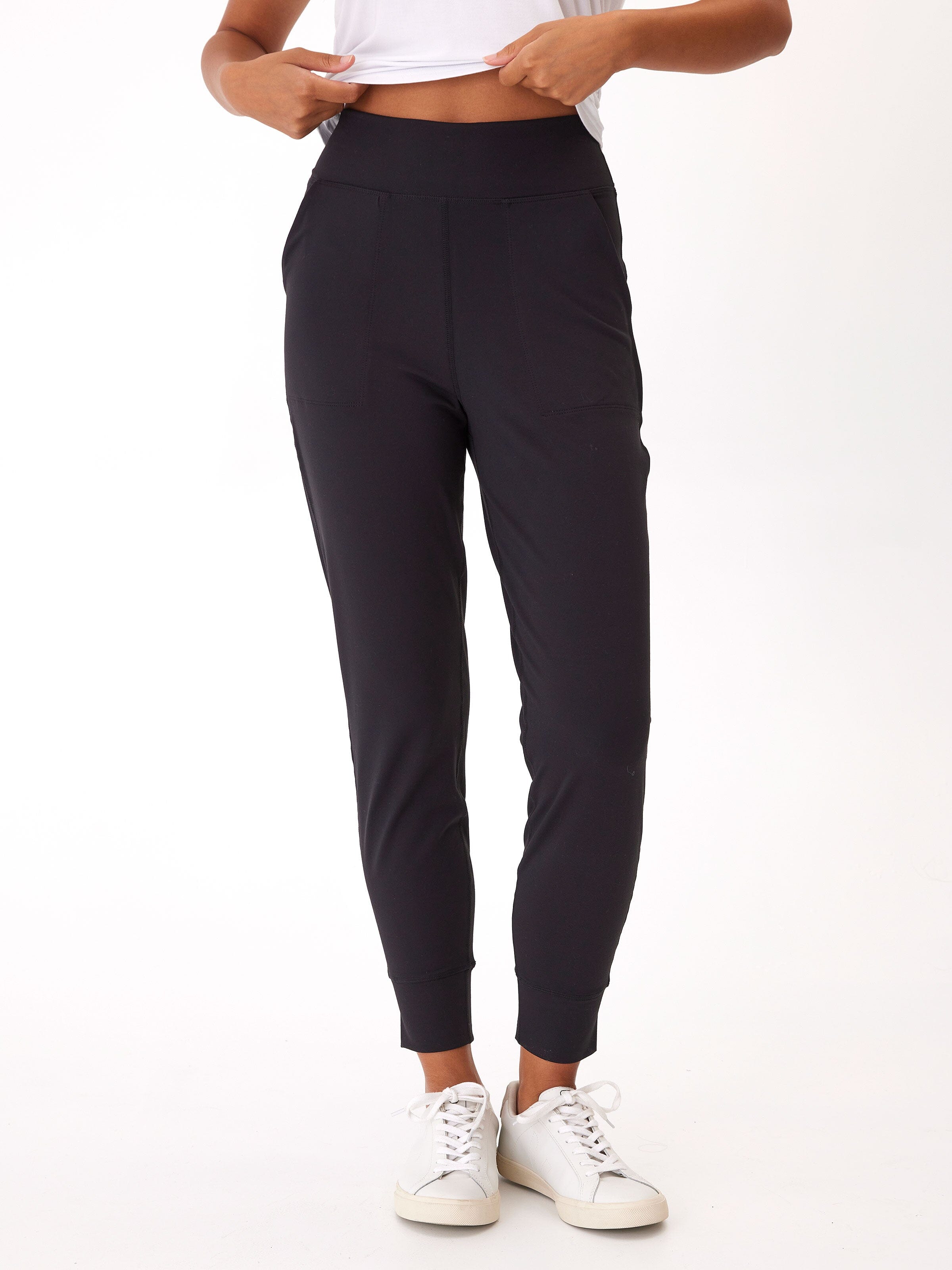 Woman wearing minimalist black Peached Performance Jersey Lydia joggers with pockets