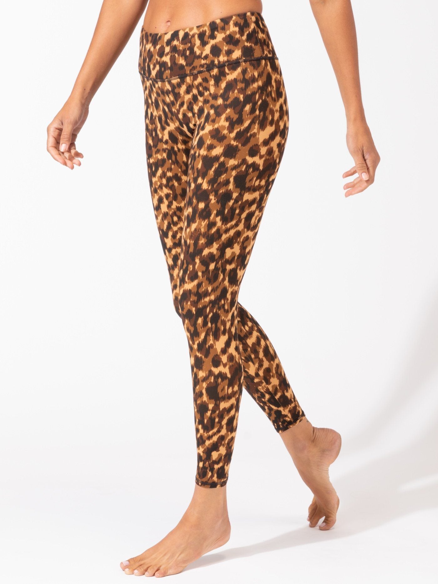 Woman wearing Monica high-rise ankle-length leggings in a brown and black leopard animal print