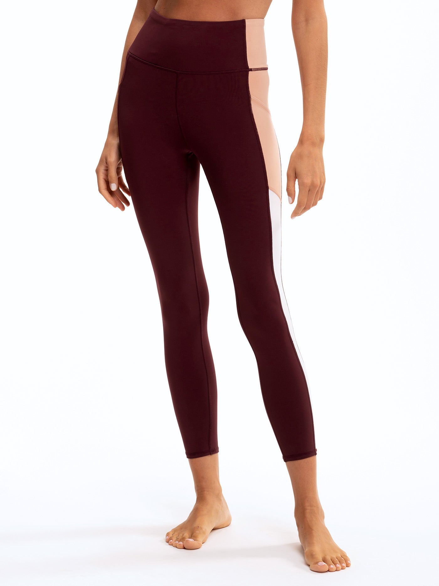 Saskia colorblock leggings in deep burgundy and soft blush-pink with high-rise waist and cell phone pocket.