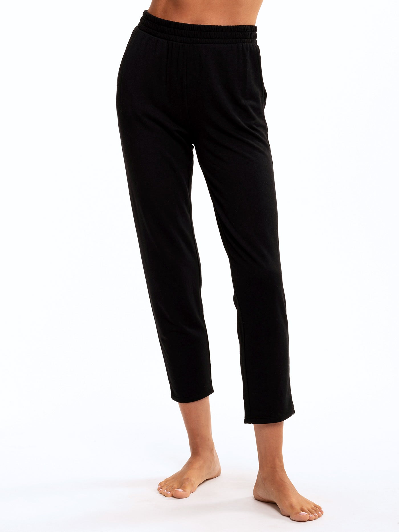 Model wearing solid black Eloraina Feather Fleece high-rise tapered lounge pants