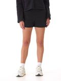 Women wearing black Neve Triblend Fleece Short 3 inch in a minimalist, sporty lounge setting.