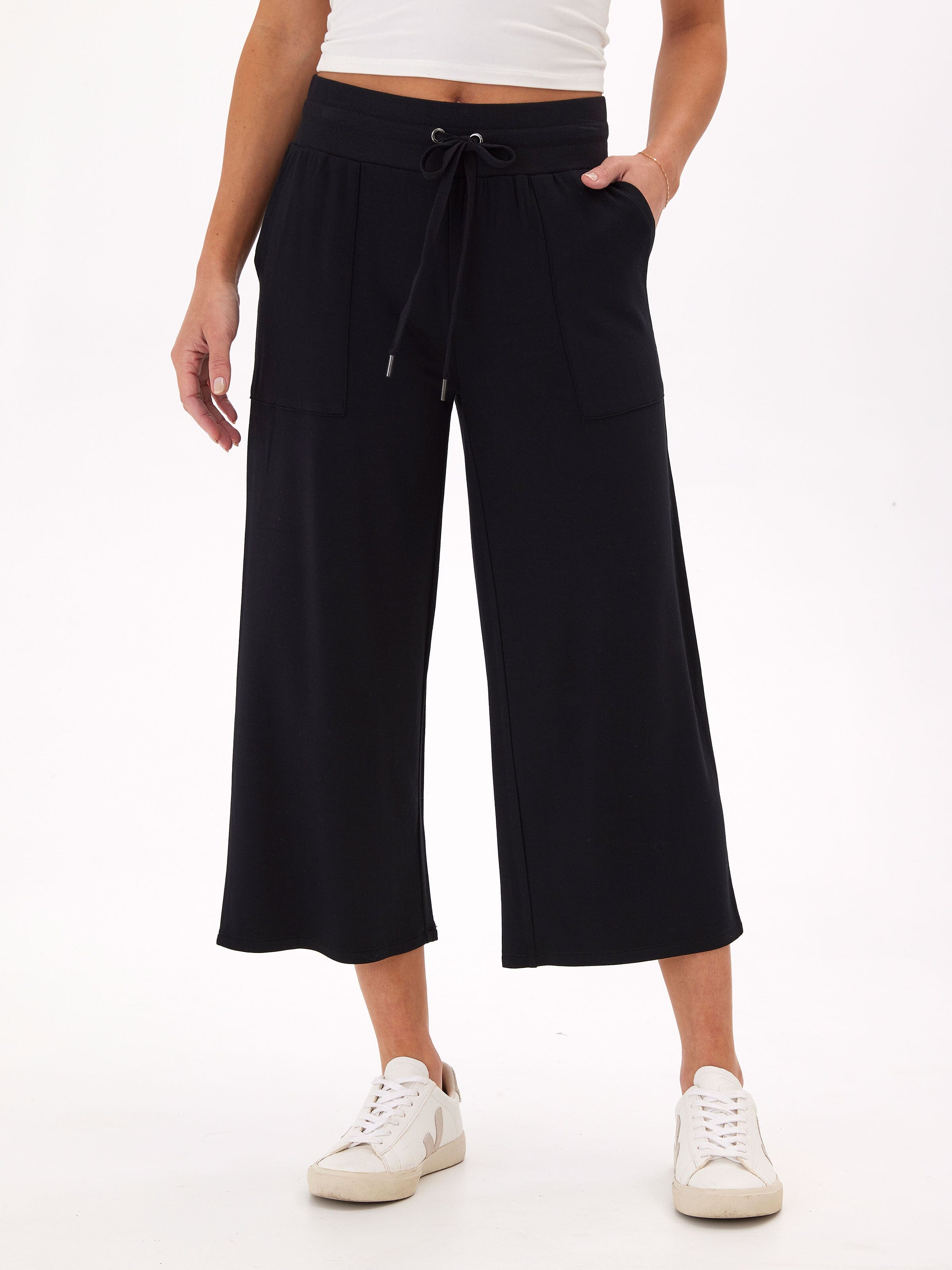 A pair of women's black feather fleece wide-leg cropped lounge pants in a minimalist style.