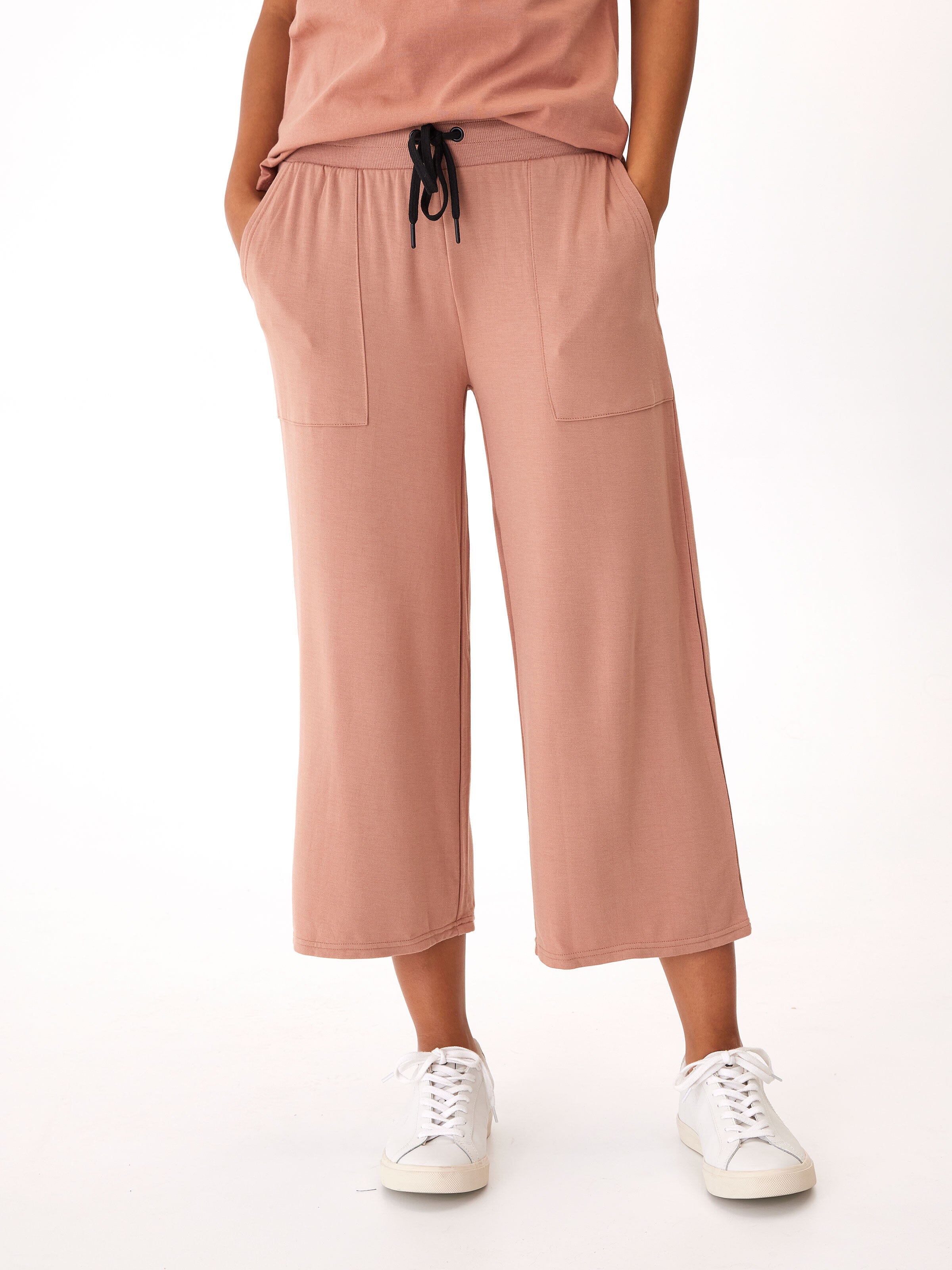 Woman wearing dusty-rose wide-leg crop pants in a minimalist loungewear setting