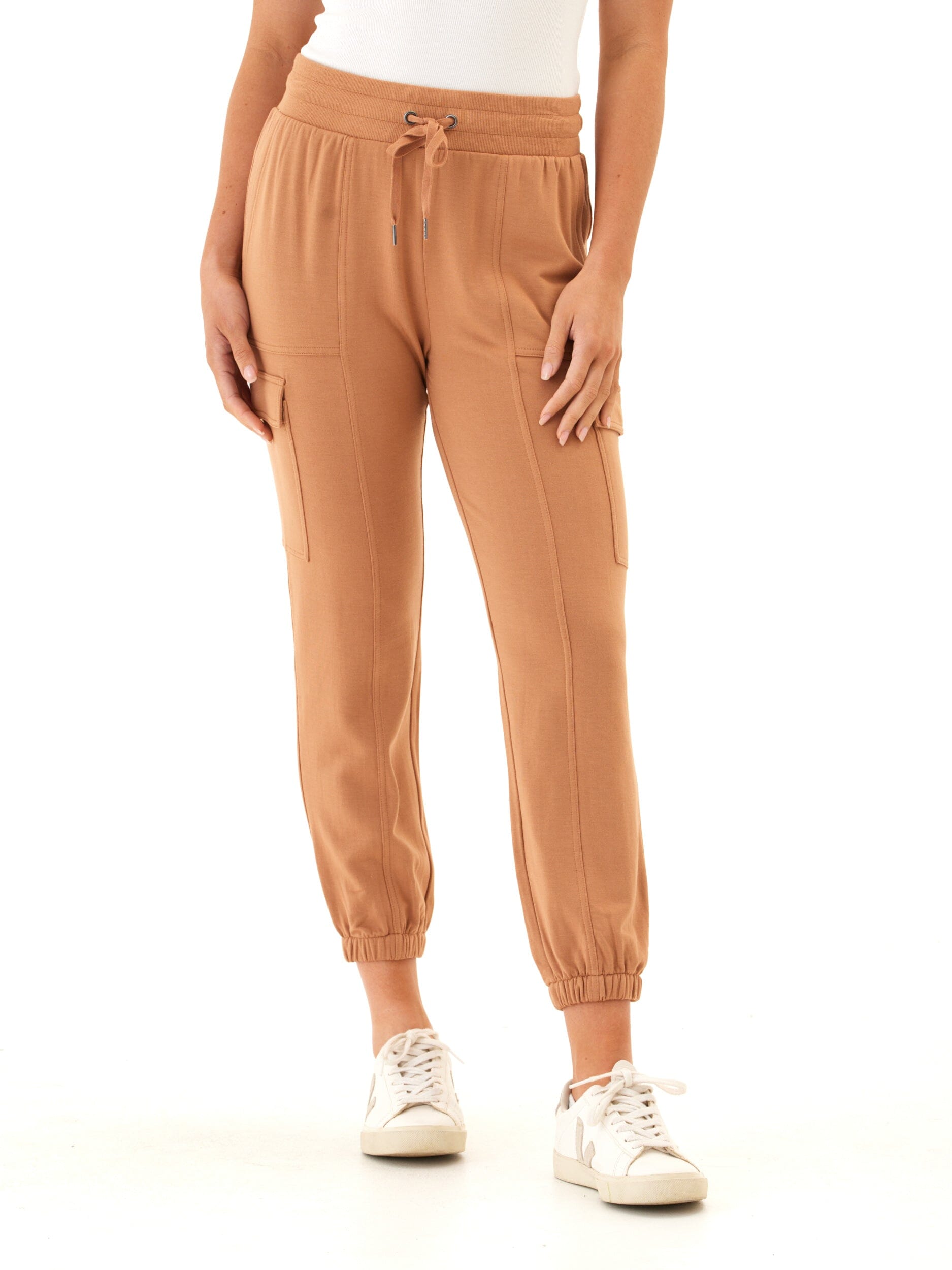 Women wearing Margot Feather Fleece Cargo Joggers in camel, featuring cargo side pockets and a relaxed knit fit.