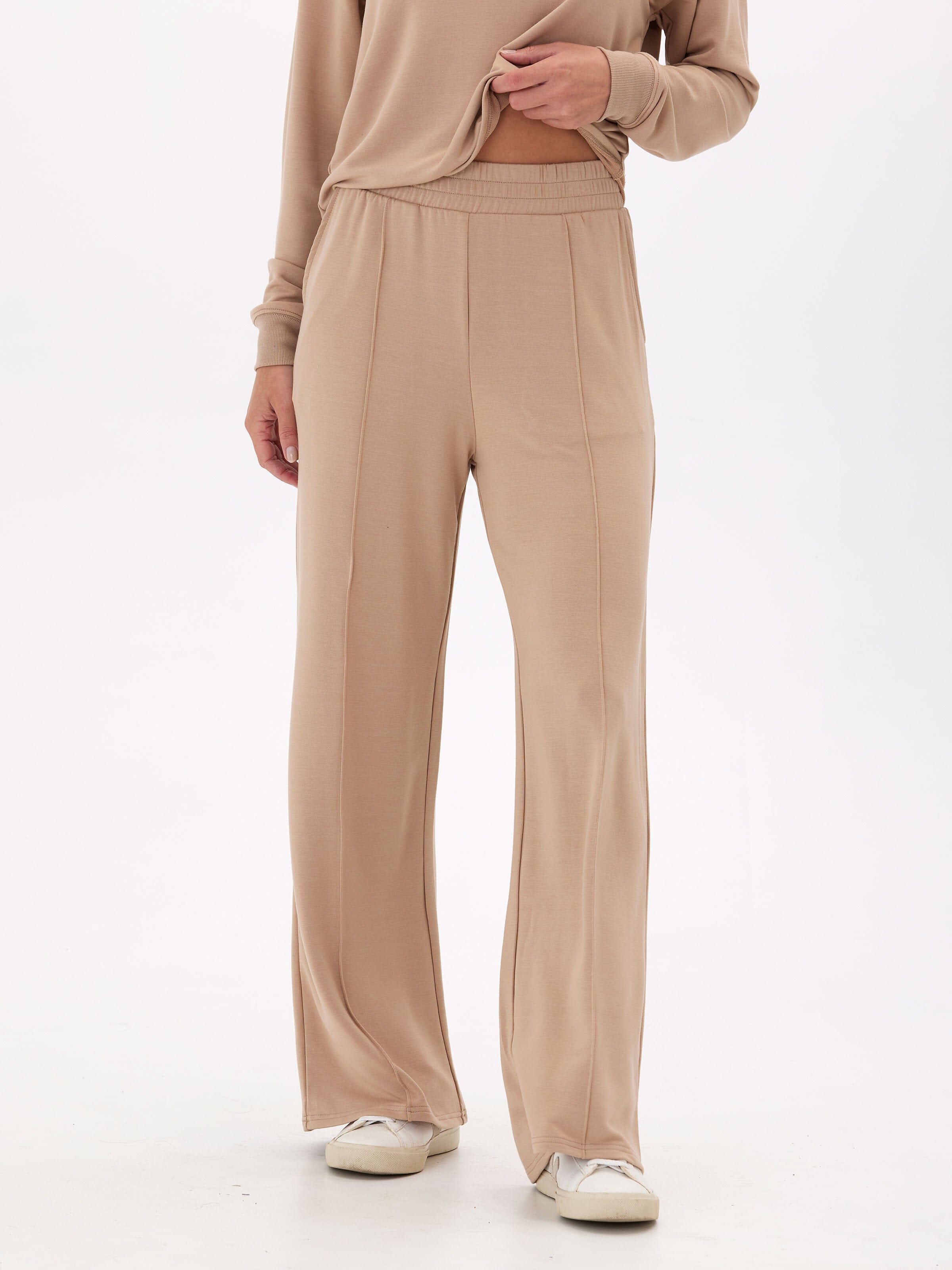 Woman wearing beige Angela Modal Terry wide leg pants in a relaxed, minimalist loungewear style