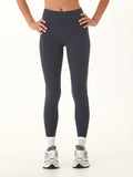Woman wearing comfortable Elena High Rise 7/8 Leggings, showcasing the flattering waistband and ankle-length cut.
