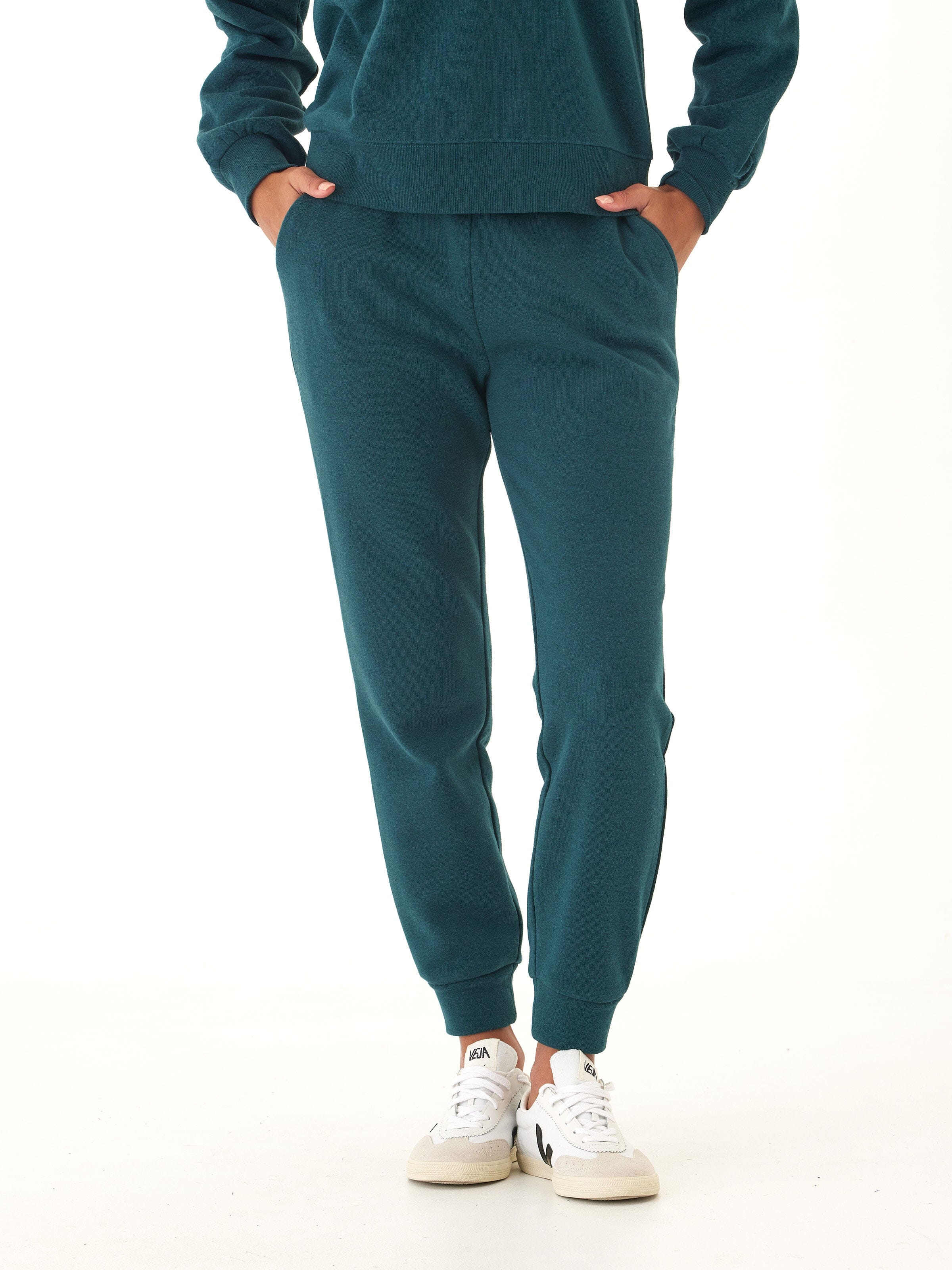 Close up of deep green triblend fleece jogger pants featuring a thick elastic waist.