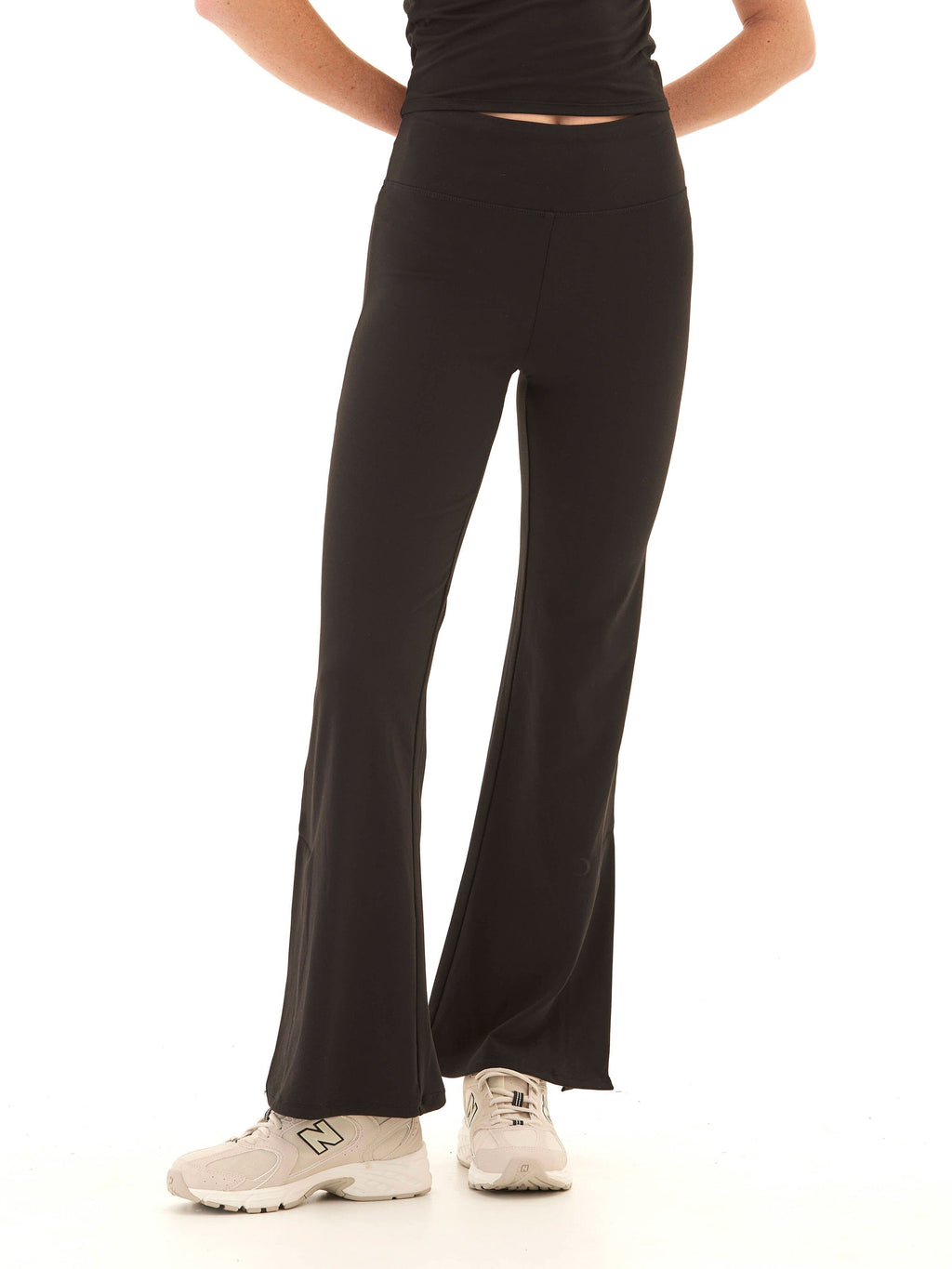 Model wearing Maybella high rise flare leggings in black with a fitted silhouette.