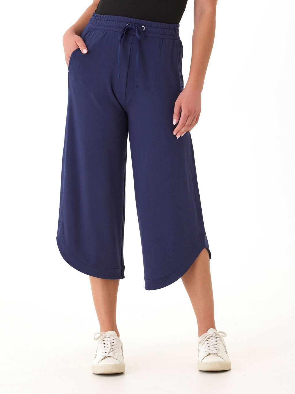 Kellyna Modal Terry Capri Dolphin Pant in navy blue featuring a wide-leg silhouette and curved hem.