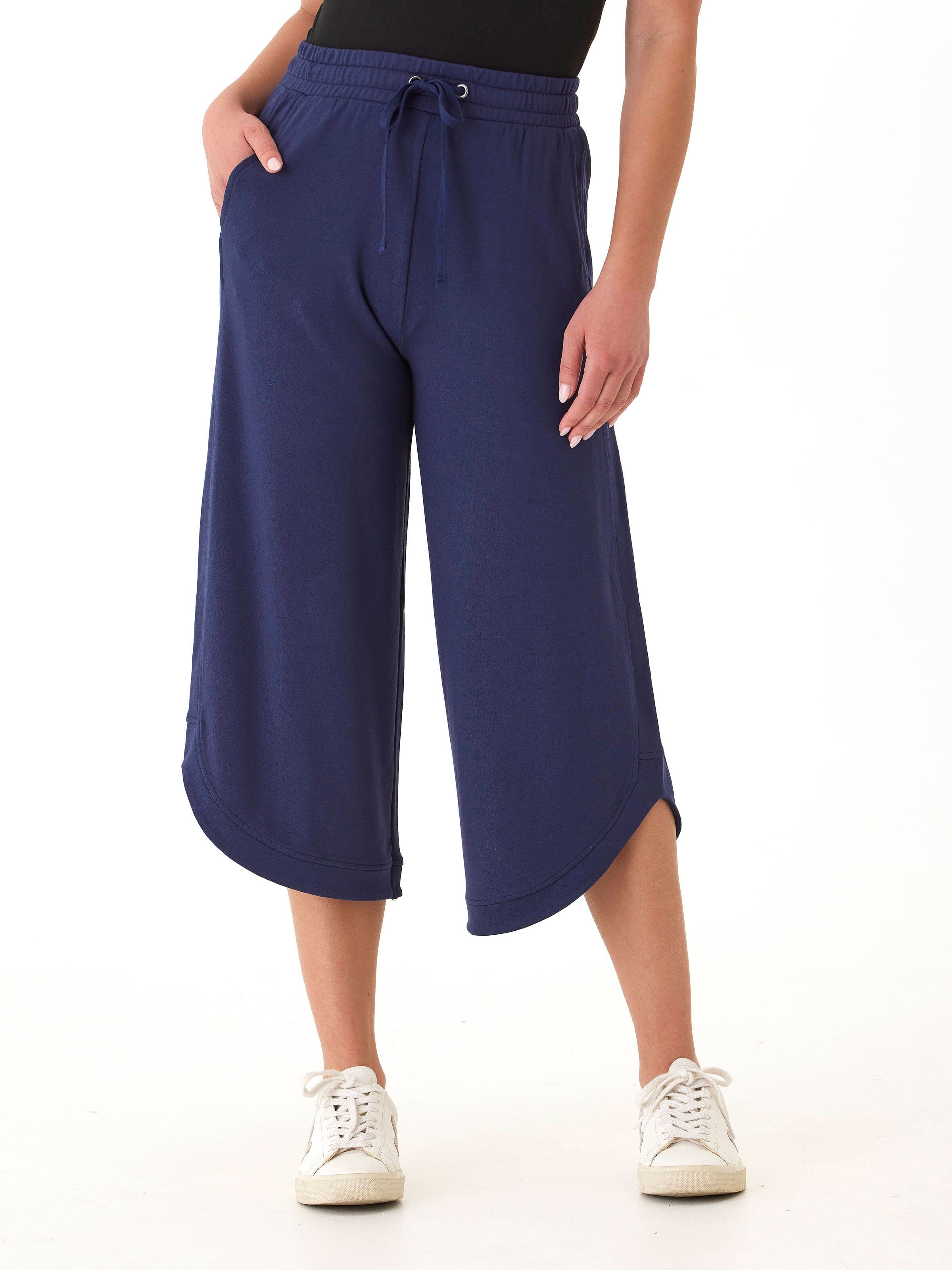 Kellyna Modal Terry Capri Dolphin Pant in navy blue featuring a wide-leg silhouette and curved hem.
