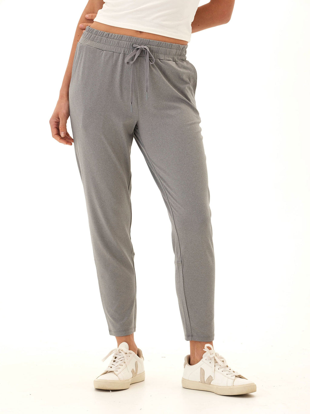 Woman wearing Lacey Luxe high-rise relaxed ankle-length jersey pants in heathered grey