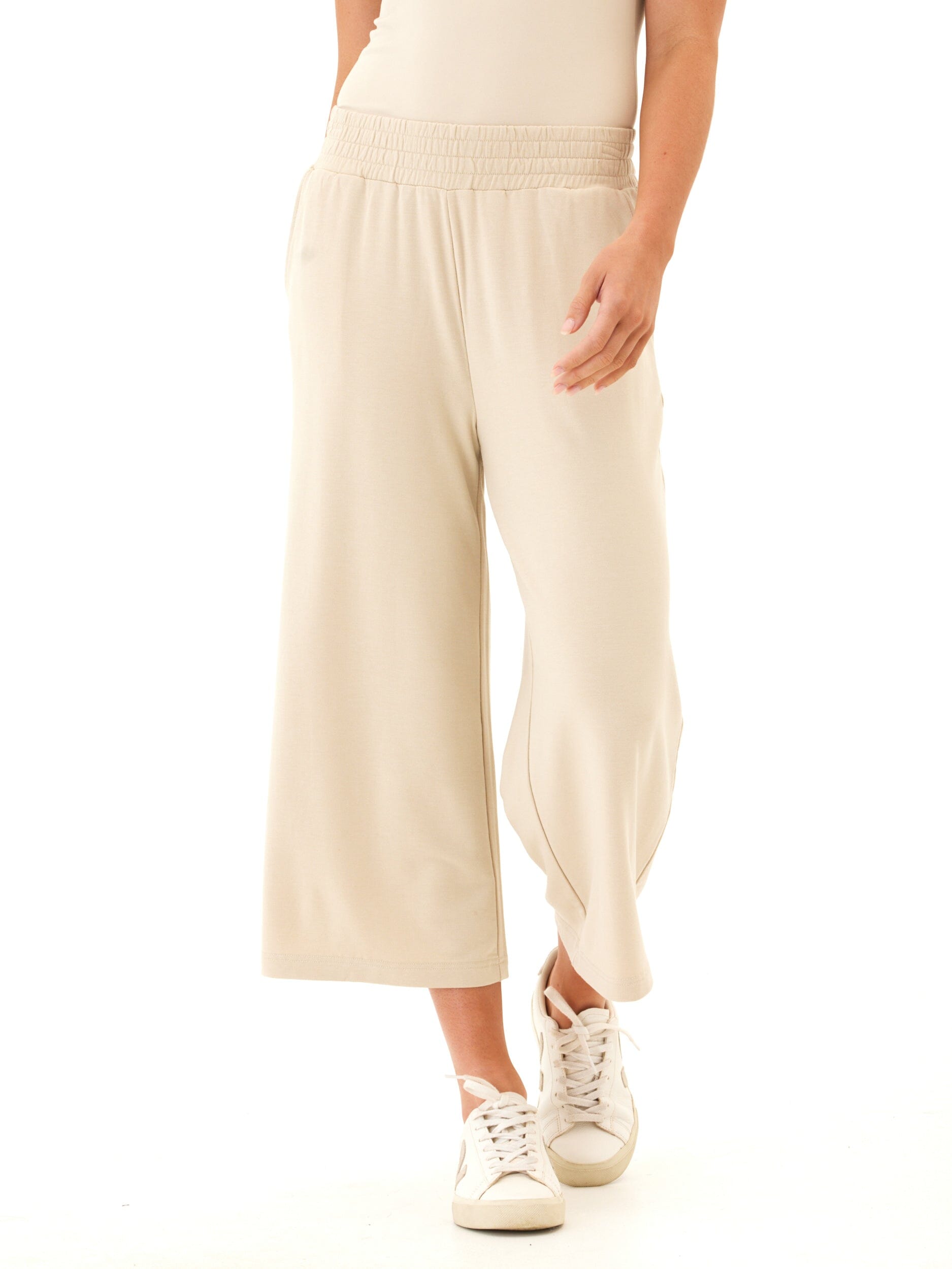 Woman wearing beige high-rise wide leg modal terry crop pants.