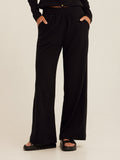 Close up of black Ivanna smocked jersey wide leg pants showing the elastic waistband detail.